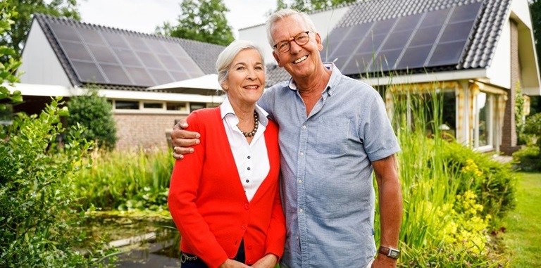 Man en vrouw voor hun huis