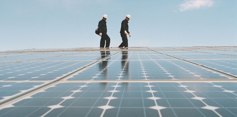 mannen lopen over zonnepanelen